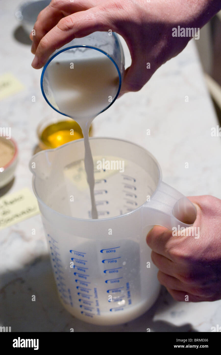 Pouring water and yeast liquid in a plastic jug. Stock Photo