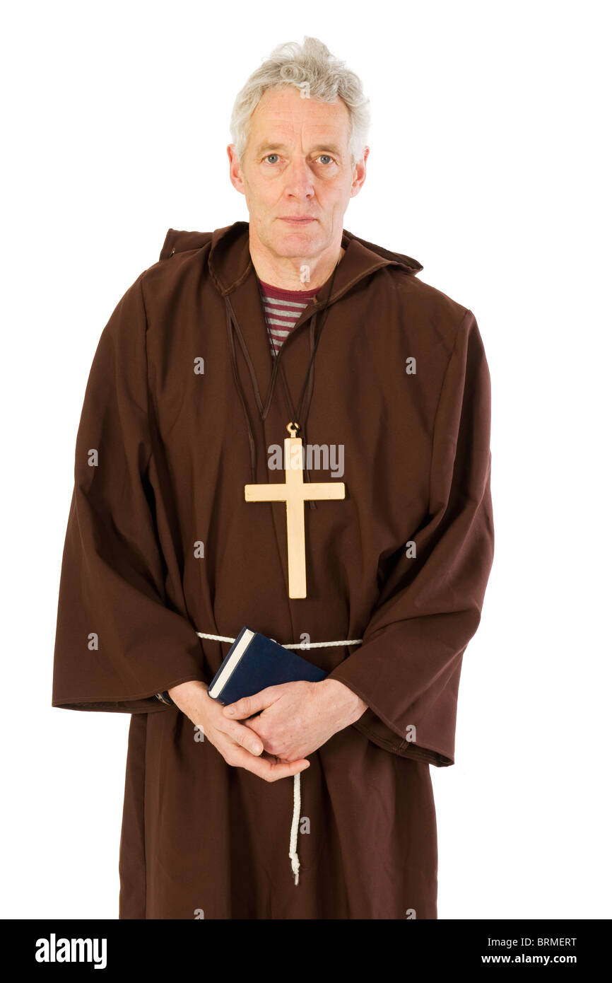 Elderly Franciscan monk with bible and cross Stock Photo