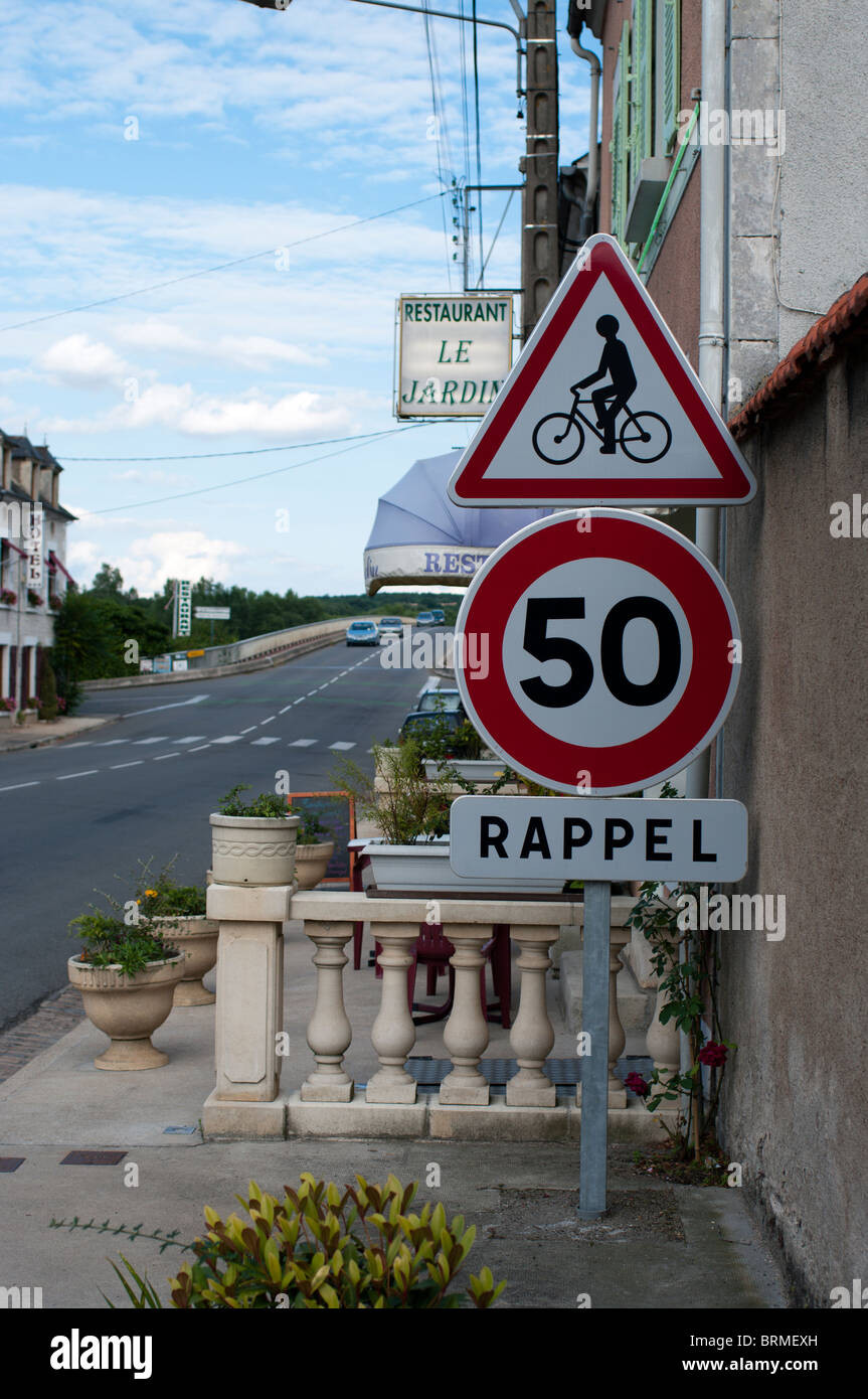 50kph speed limit reminder sign in French village with additional warning to look out for cyclists Stock Photo