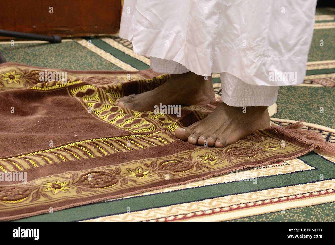 Feet on a prayer mat Stock Photo Alamy