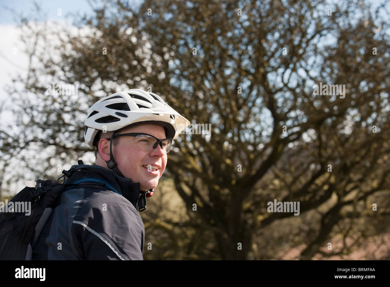 Man wearing bike helmet in hi-res stock 