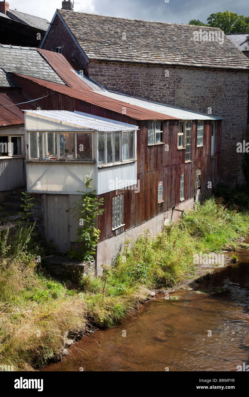 Iron sheet clad extension to building beside river Talgarth Wales UK Stock Photo