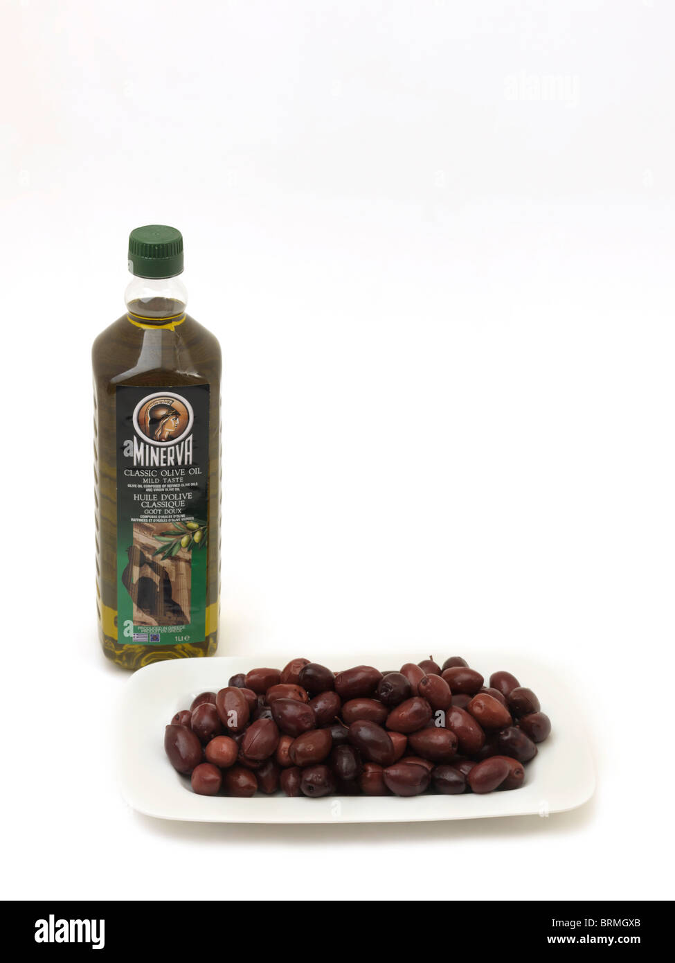 Bottle Of Minerva Olive Oil And A Plate Of Kalamata Olives Stock Photo