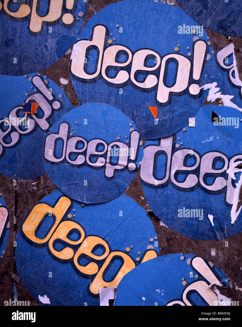 Multiple blue stickers with the writing 'deep!' glued to a wall in Munich, Germany Stock Photo