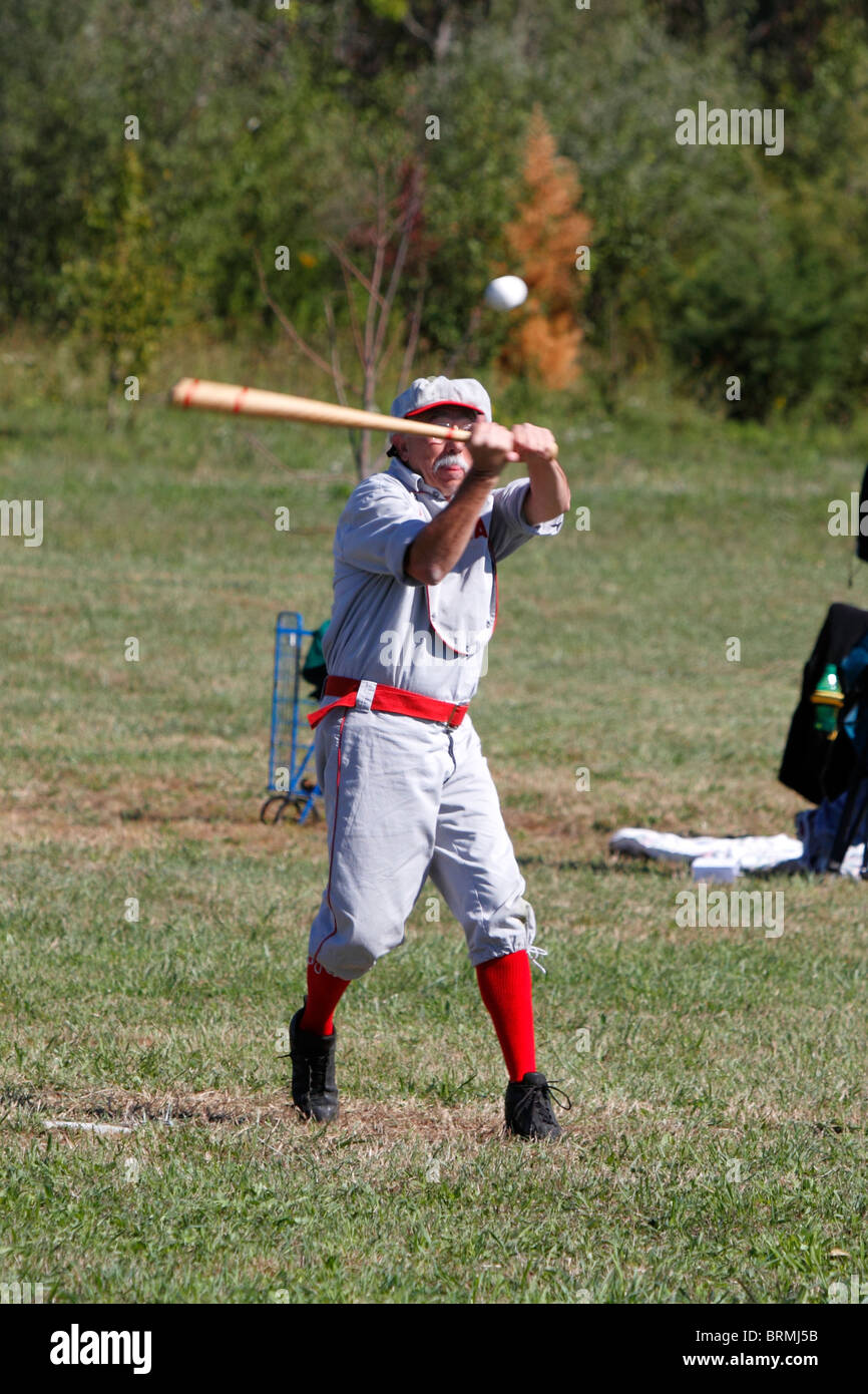 Baseball player in vintage uniform about to strike the ball Stock Photo