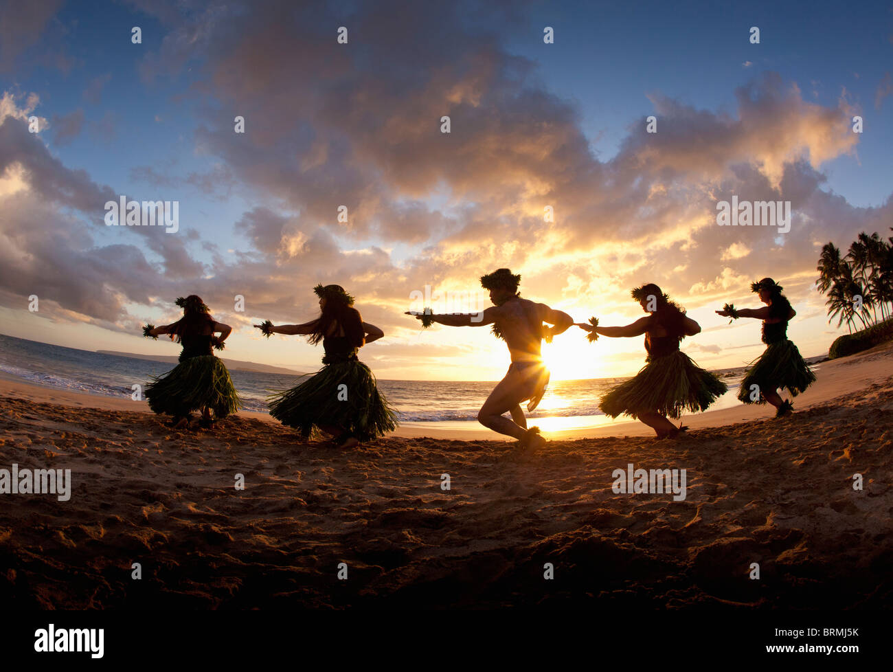 Silhouette of hula dancers at sunset at Palauea Beach, Maui, Hawaii. Stock Photo