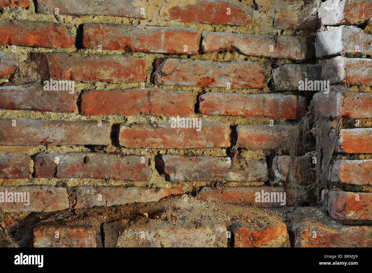 Old shabby brick wall with dirt and webs. Stock Photo