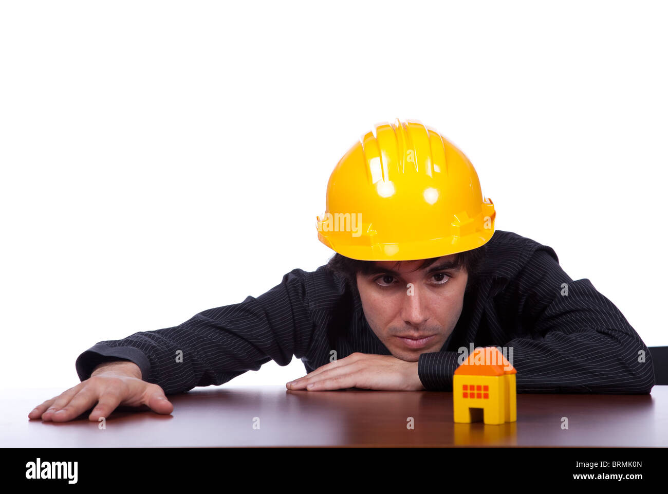 young construction engineer looking to a small house Stock Photo - Alamy