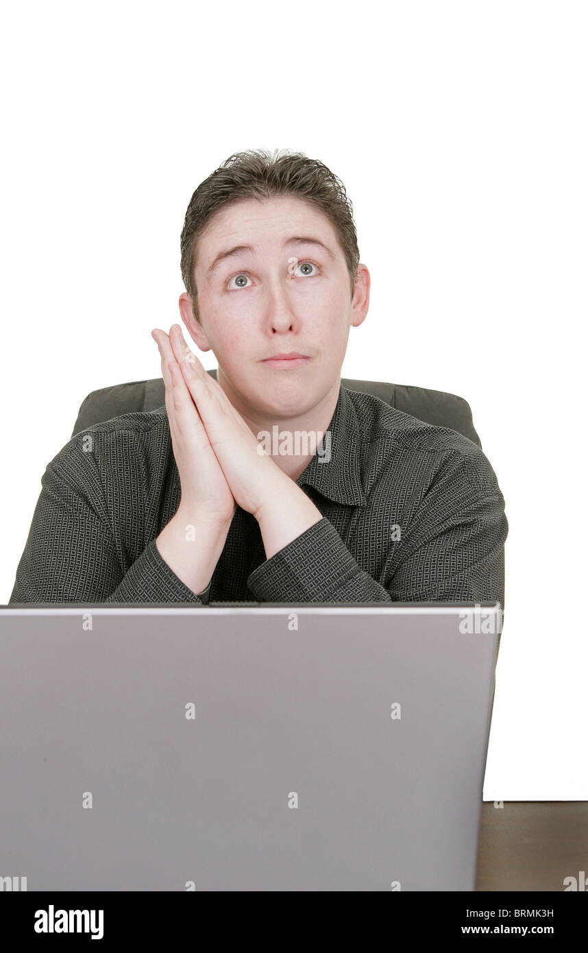man praying for help on his computer work Stock Photo