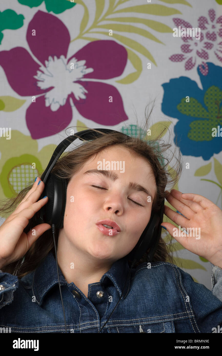 Girl listening on headphones singing Stock Photo Alamy