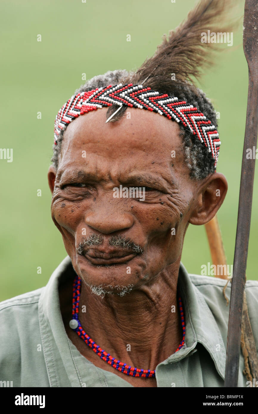 A portrait of an old bushman (about 60 year old) with beaded headband and ostrich feather Stock Photo