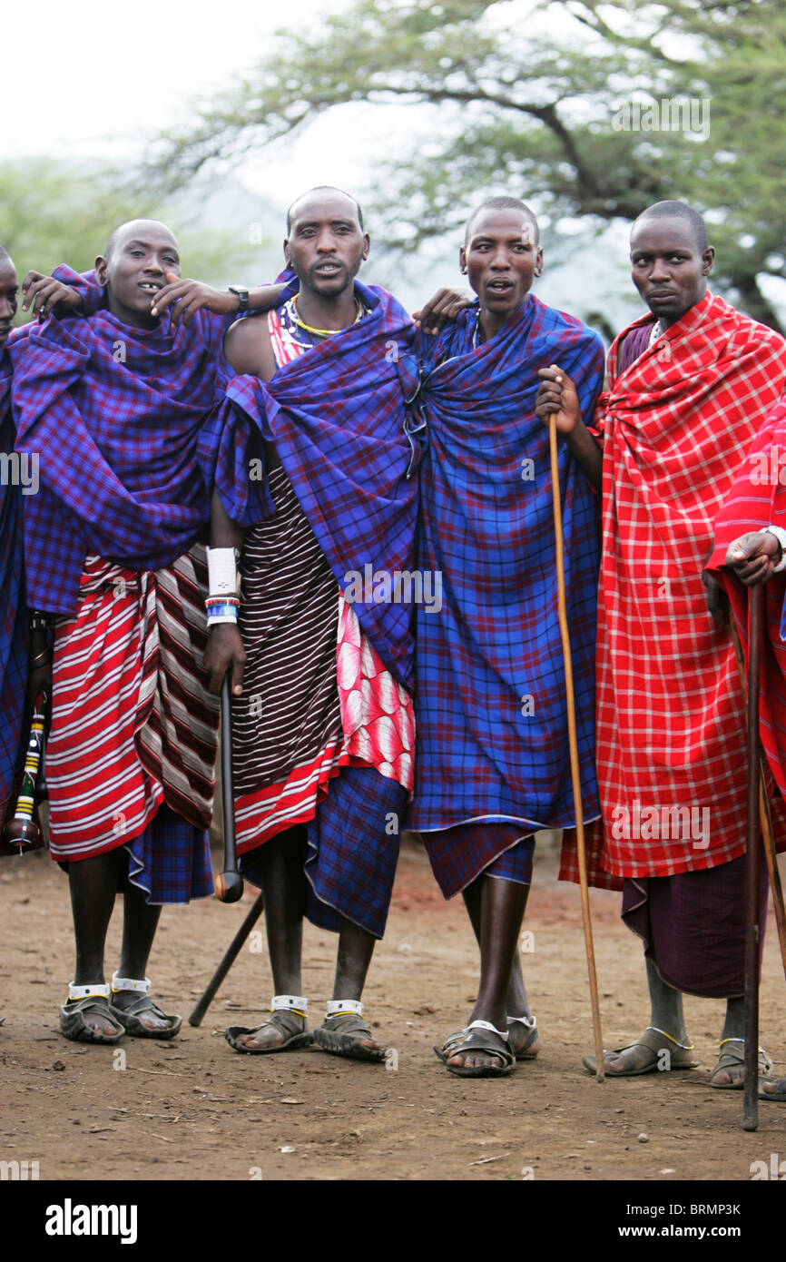 Maasai men wearing the traditional shuka and carrying spears Stock Photo