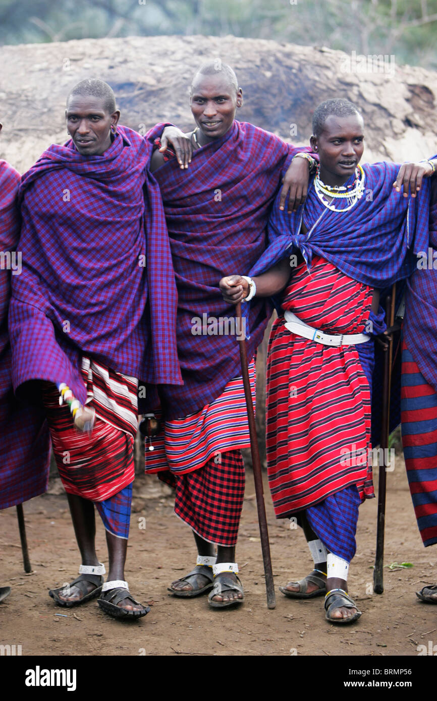 Maasai men wearing the traditional shuka and carrying spears Stock