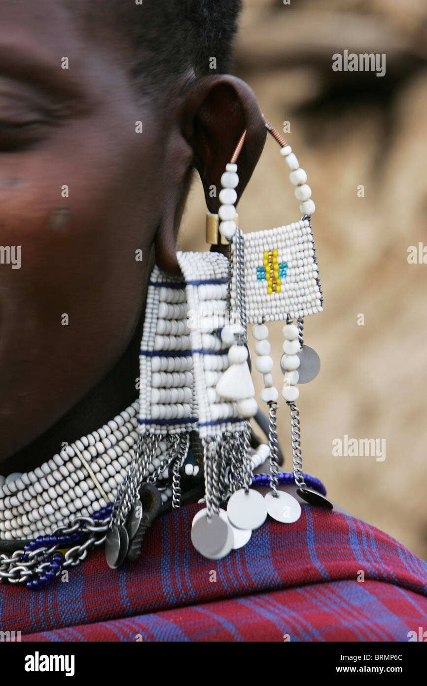 The side of a Maasai woman's face showing pierced ears and heavy beaded earrings Stock Photo
