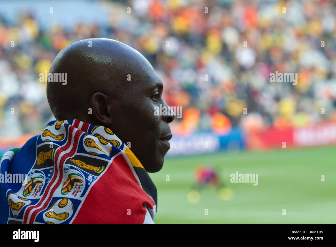 Rear view of a soccer supporter draped in a South African World cup flag during the 2010 world cup Stock Photo