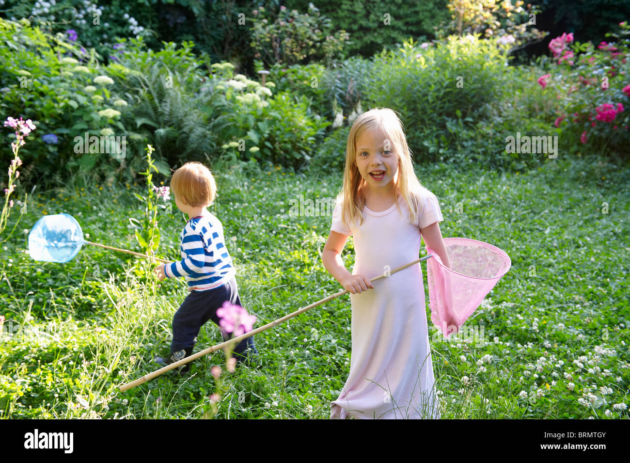 Brother and sister with butterfly nets Stock Photo