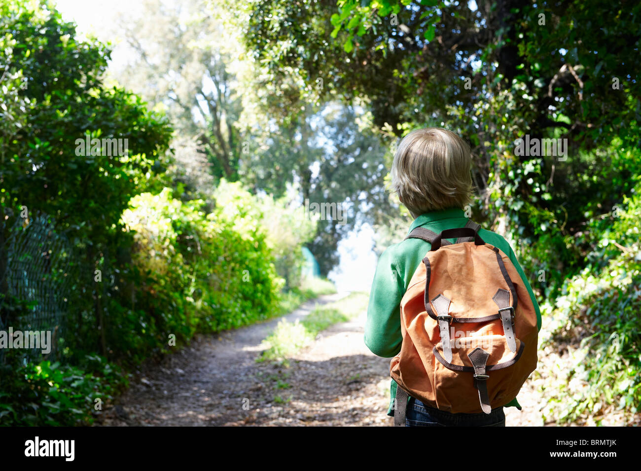 Boy with his backpack, walking Stock Photo