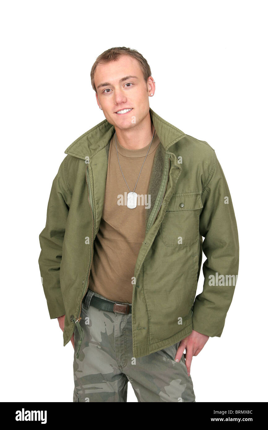 one fit attractive soldier in green and brown with dogtags and jacket half length portrait over white Stock Photo