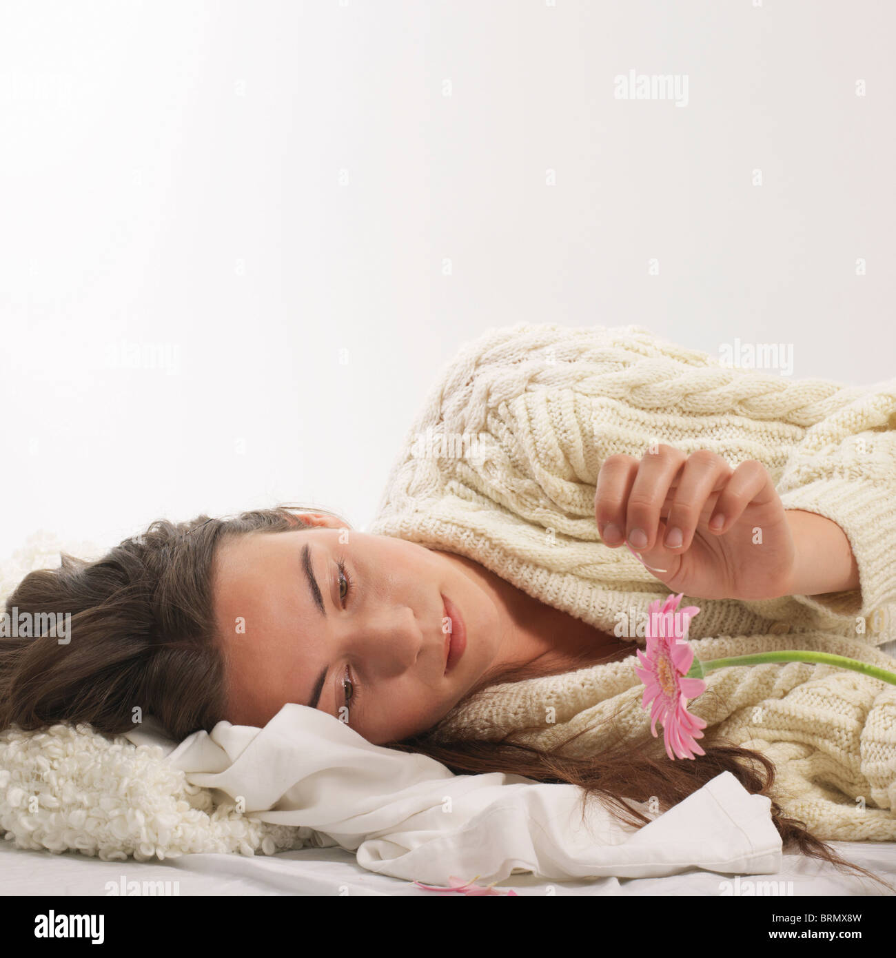 Woman reclined with pink flower Stock Photo