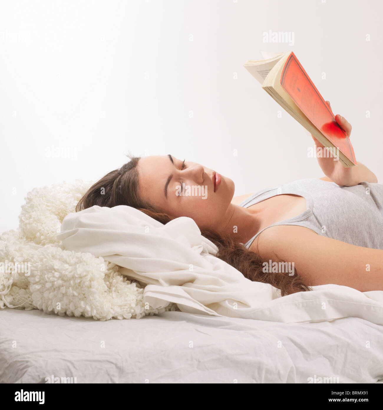 Woman reclined with reading  book Stock Photo