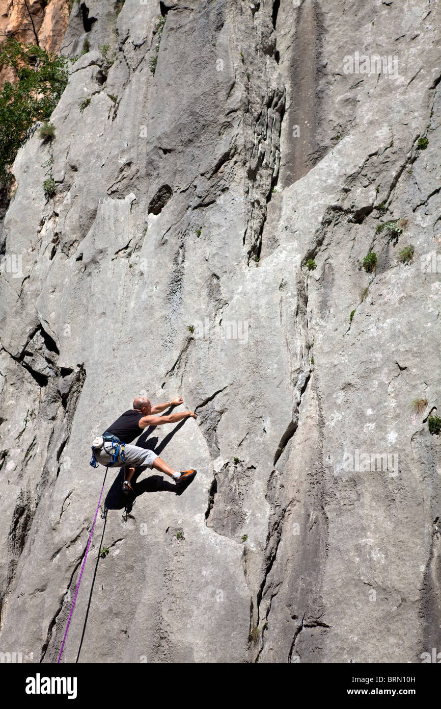 Rock climber climbing rock face Stock Photo