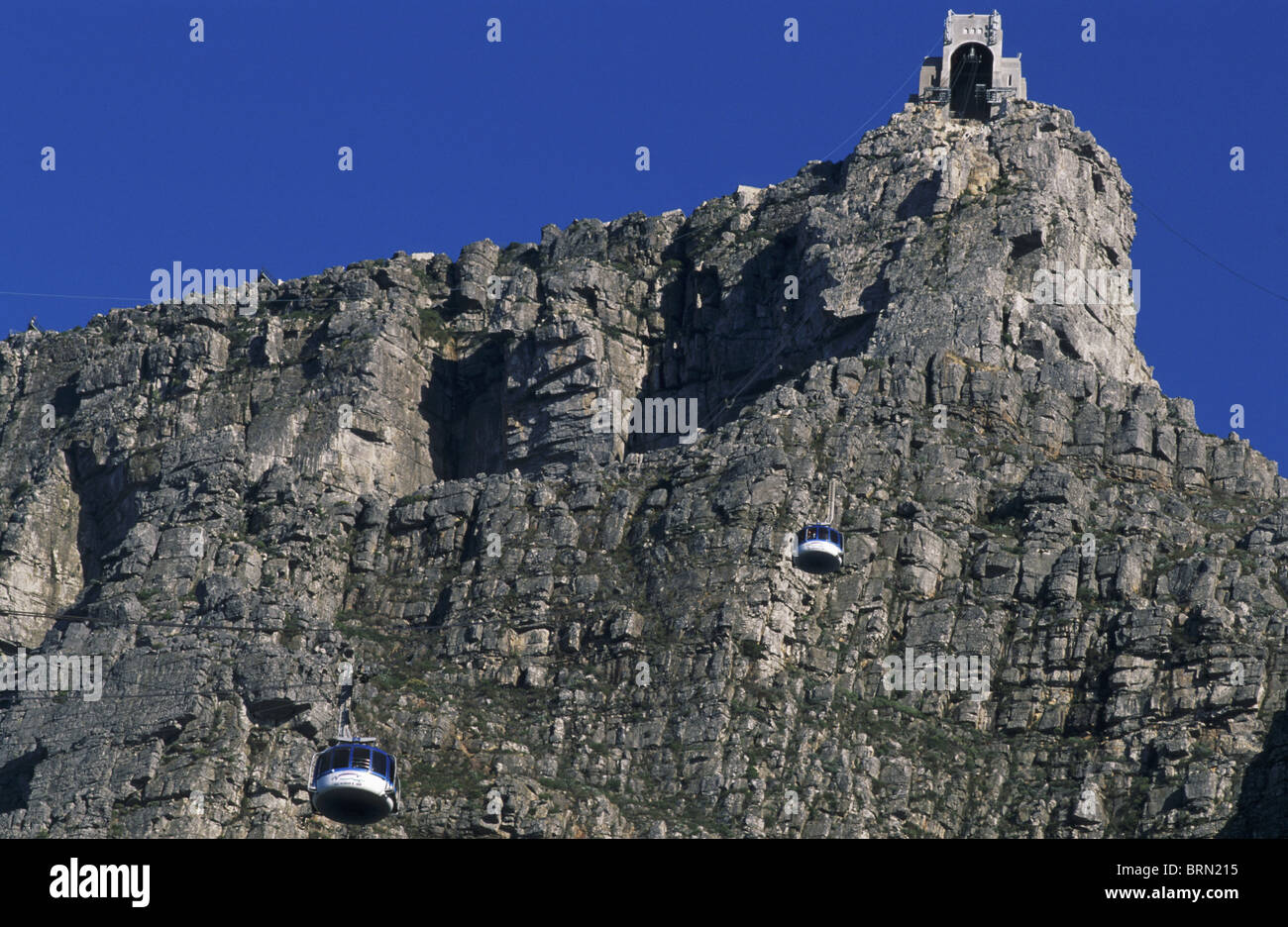Two cable cars pass one another on Table Mountain in Cape Town. Stock Photo