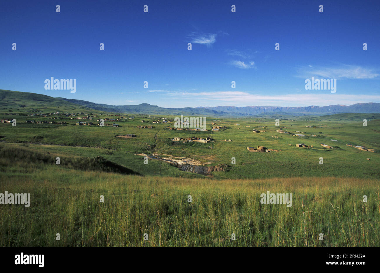 The rural lands and scattered rural Zulu dwellings in the escarpment area of the Drakensberg near Injasuti Stock Photo