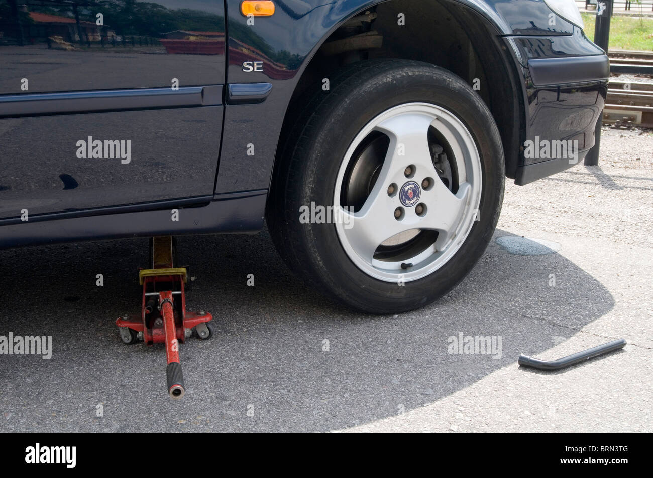 changing a wheel flat tire tyre tires jack jacks jacked up jacking a car  cars wheel brace nut nuts wheels wheelnut wheelnuts cha Stock Photo - Alamy