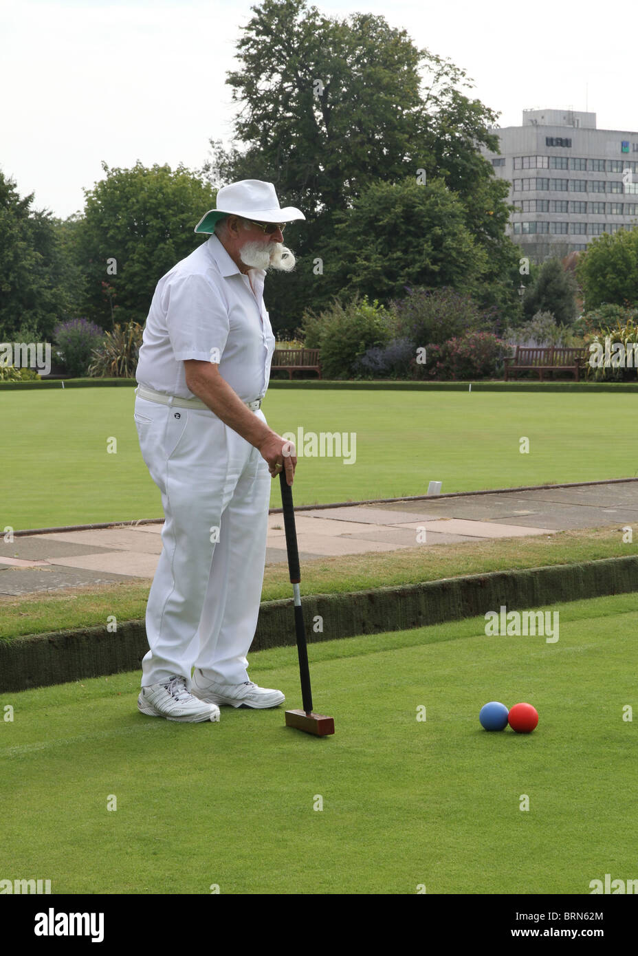 Croquet player with large moustache and mallet at Field Place in