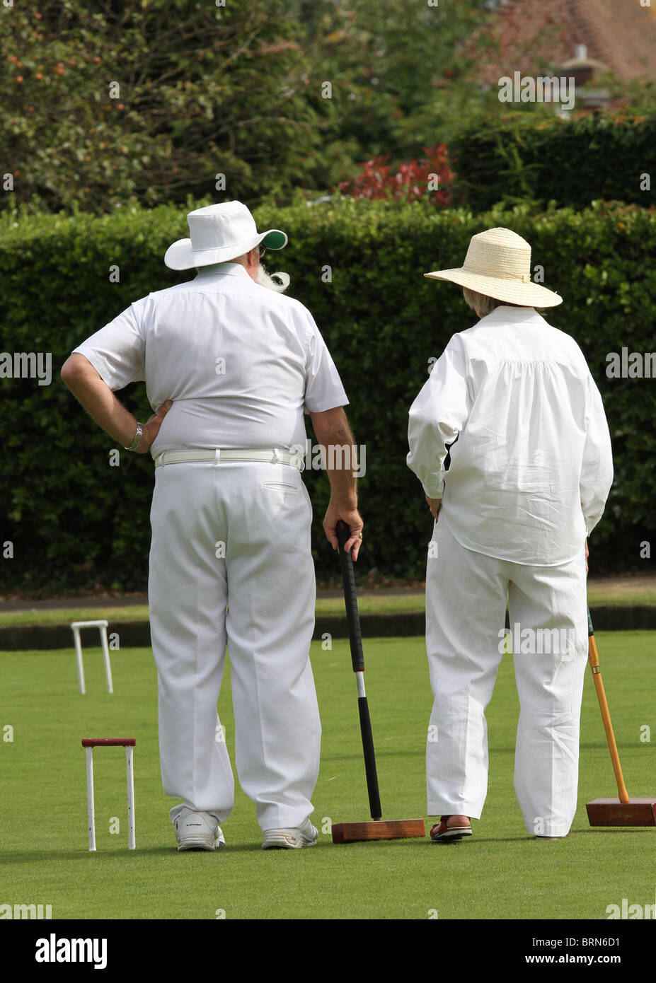 Two croquet players with mallets at Field Place in Worthing, West Sussex. Stock Photo
