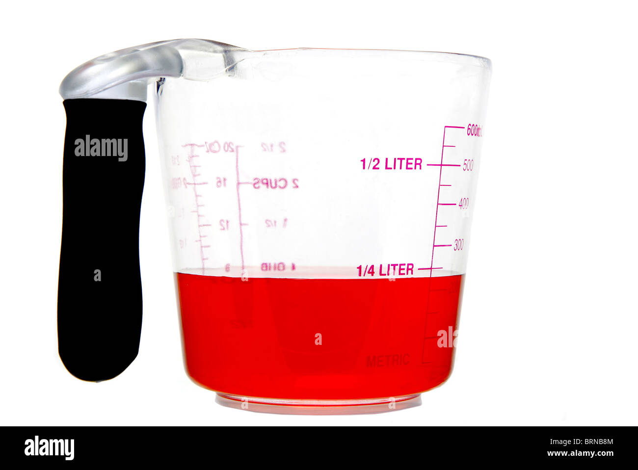 metric unit measuring cup with red liquid inside Stock Photo