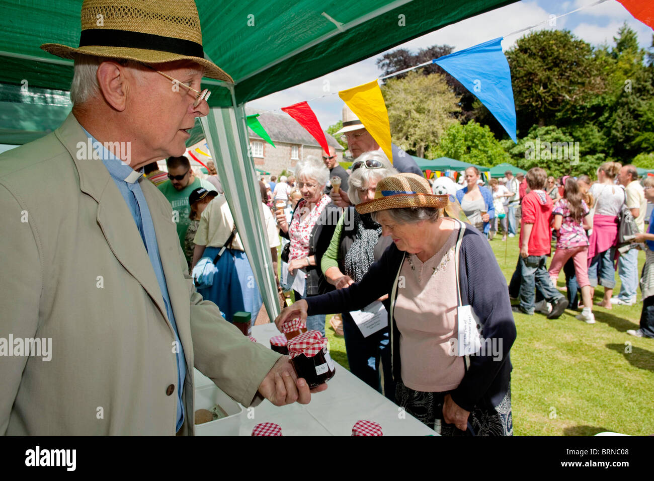 Curate Hugh Willis, selling his home made jars of jam at the annual