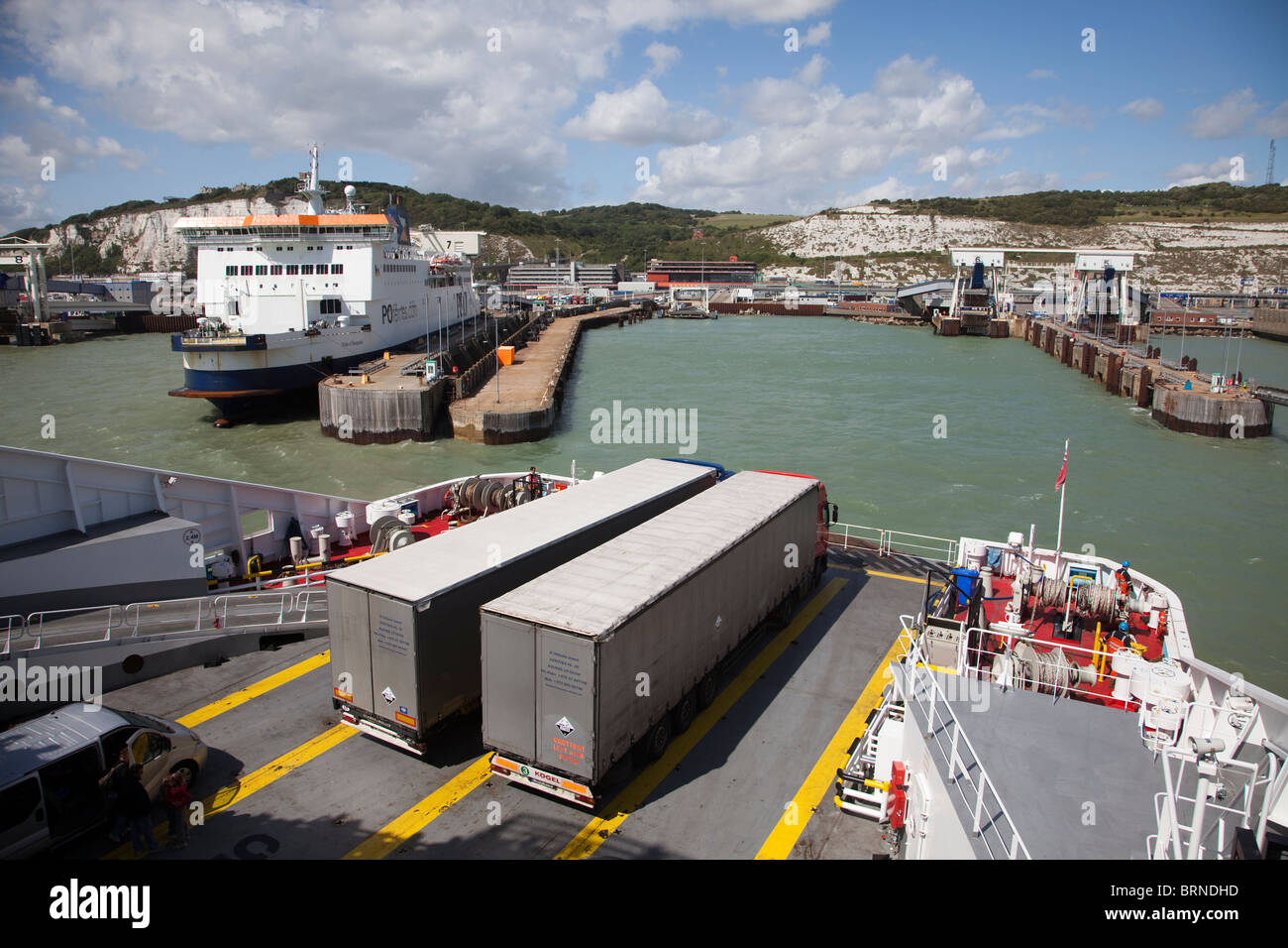 Transport lorries on ferry arriving in Dover harbour England UK Stock Photo