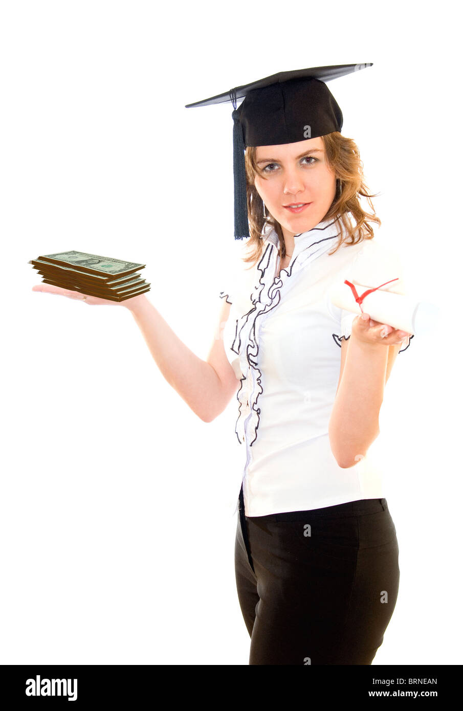 Young woman with graduation diploma in one hand, a lot of money in other hand, and graduation hat on her head, isolated on white Stock Photo