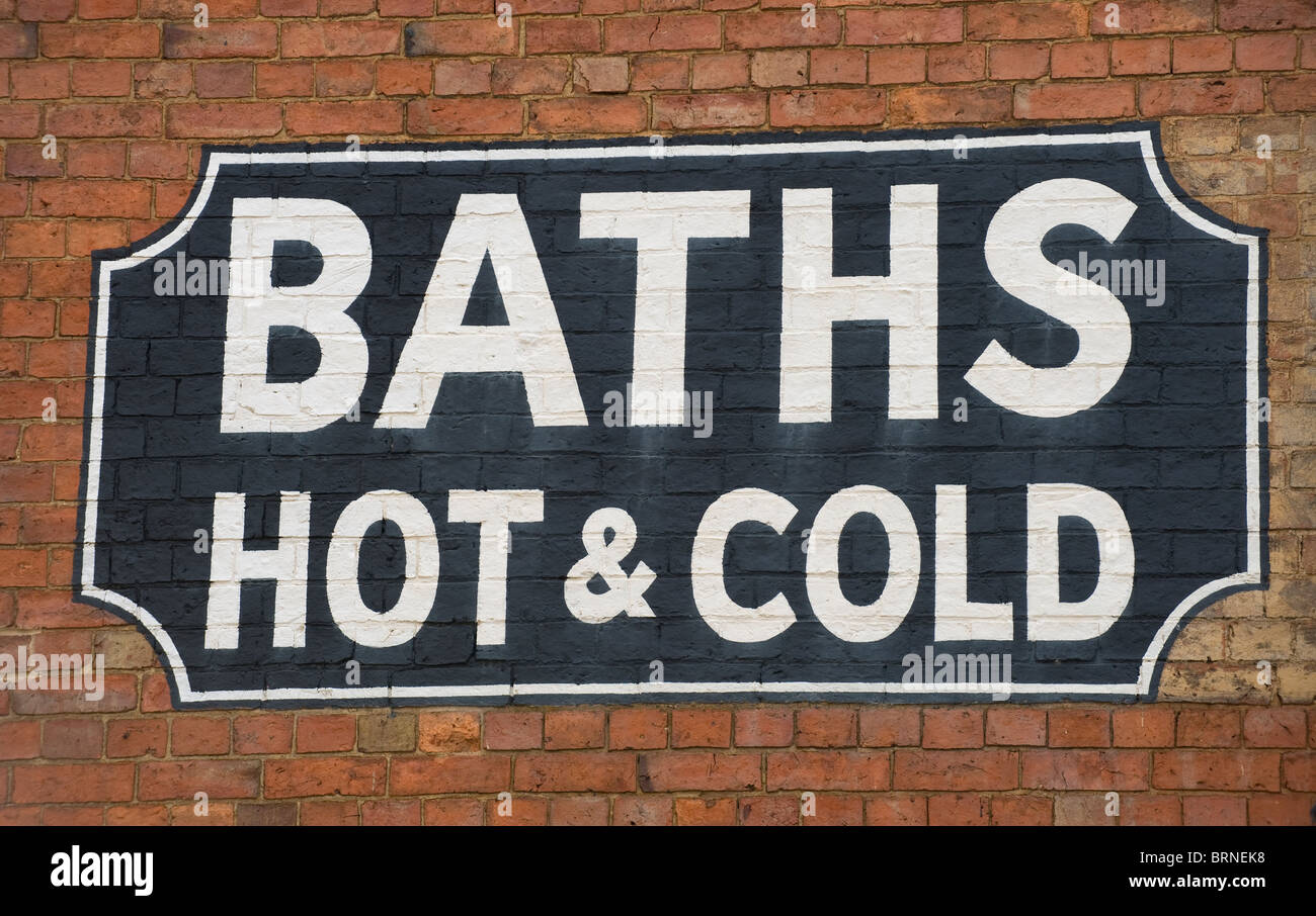 A hot and cold baths sign painted on the brickwork of a Victorian building  in Banbury Oxfordshire Stock Photo