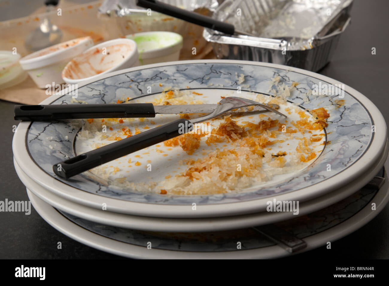empty dirty plates and fast food cartons from an indian home takeaway Stock Photo