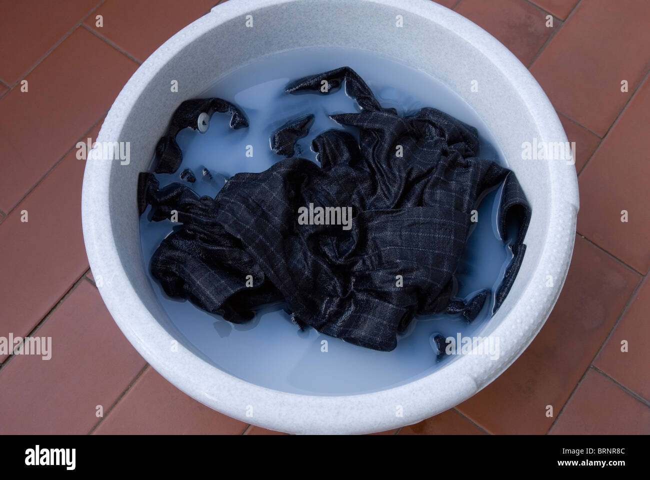 clothes in washing tub Stock Photo Alamy