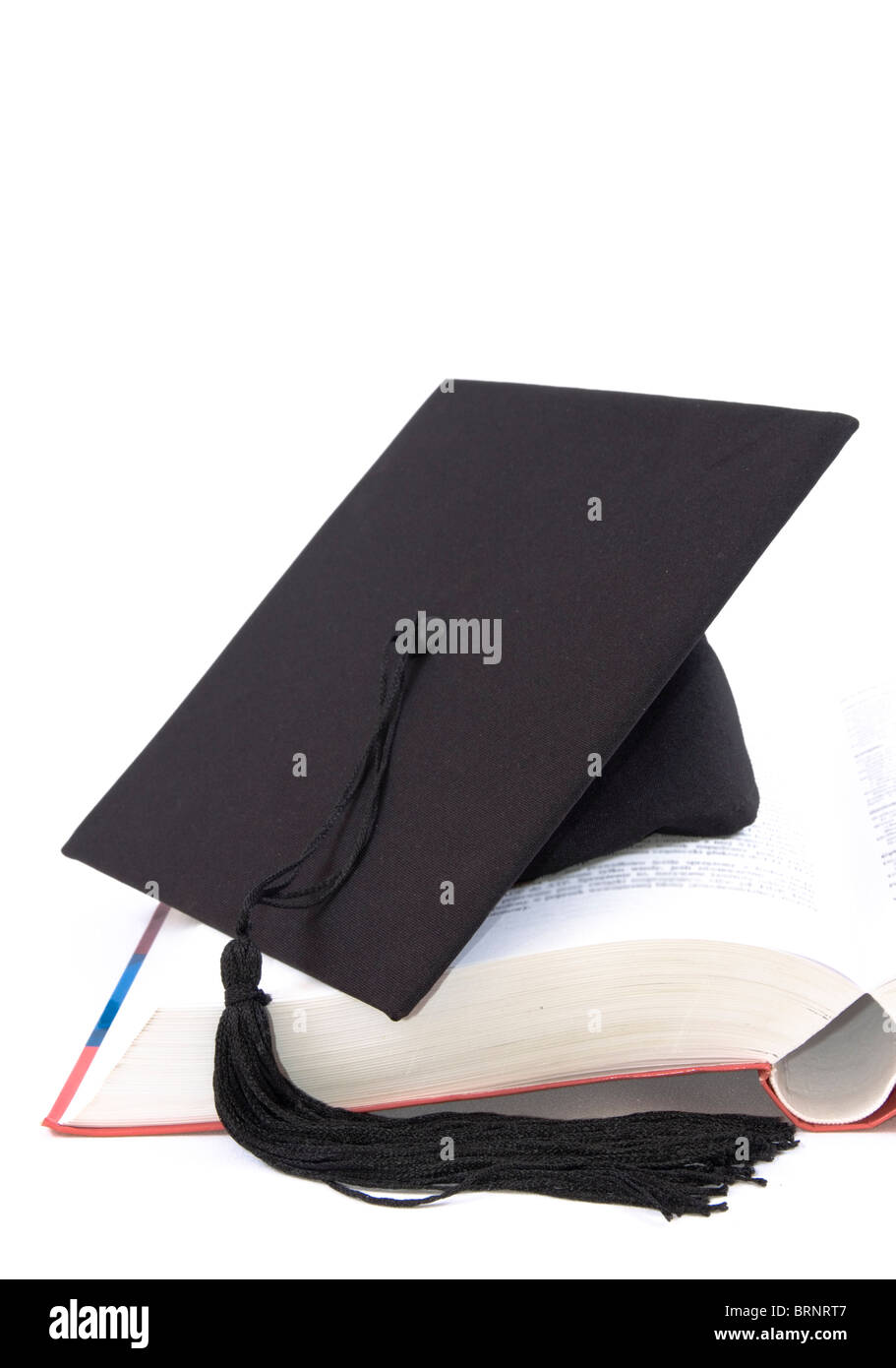 Student hat on a big open book, against a white background Stock Photo