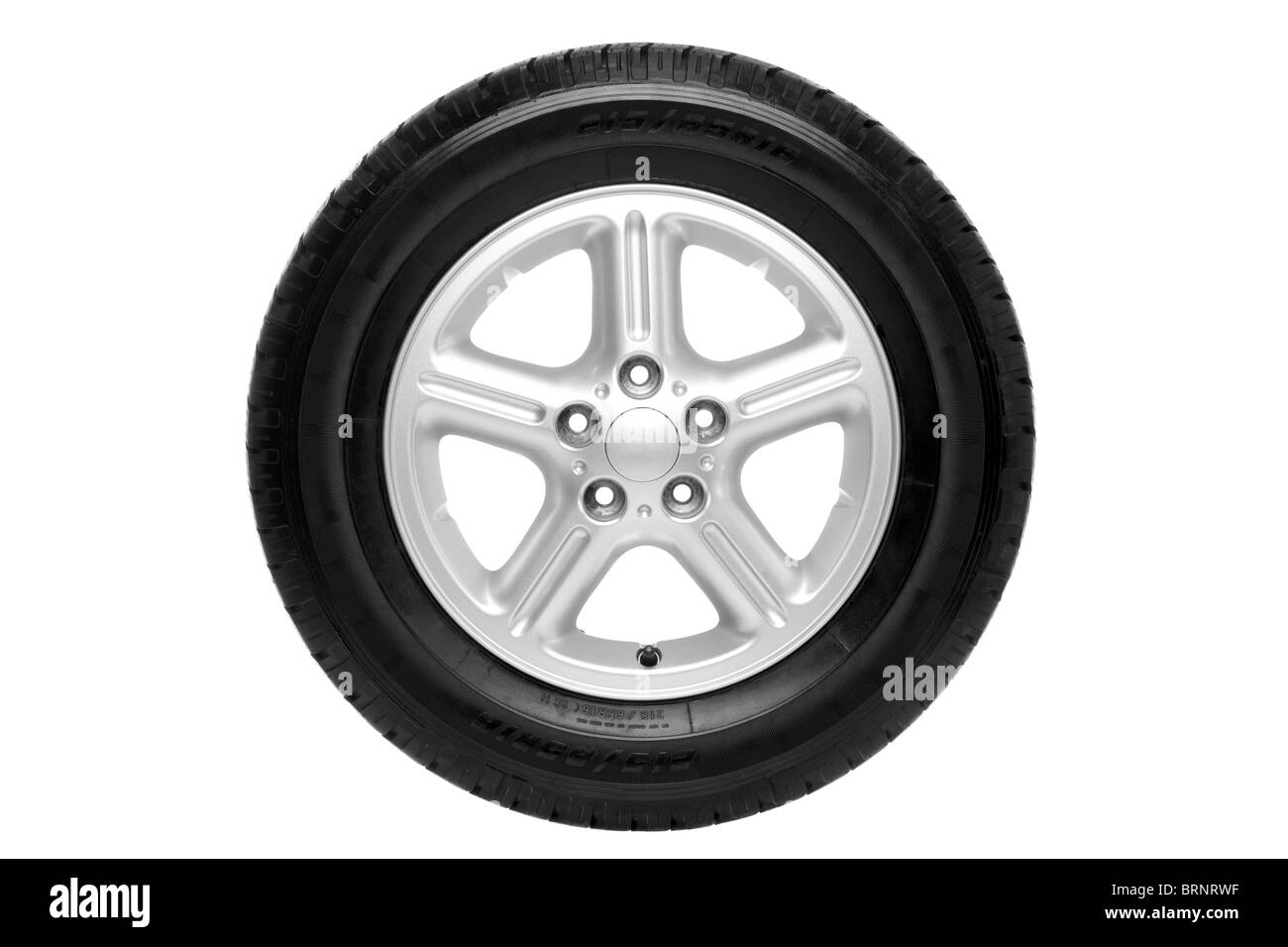 Photo of a car tyre (tire) on a five spoke alloy wheel isolated on a white background with clipping path. Stock Photo