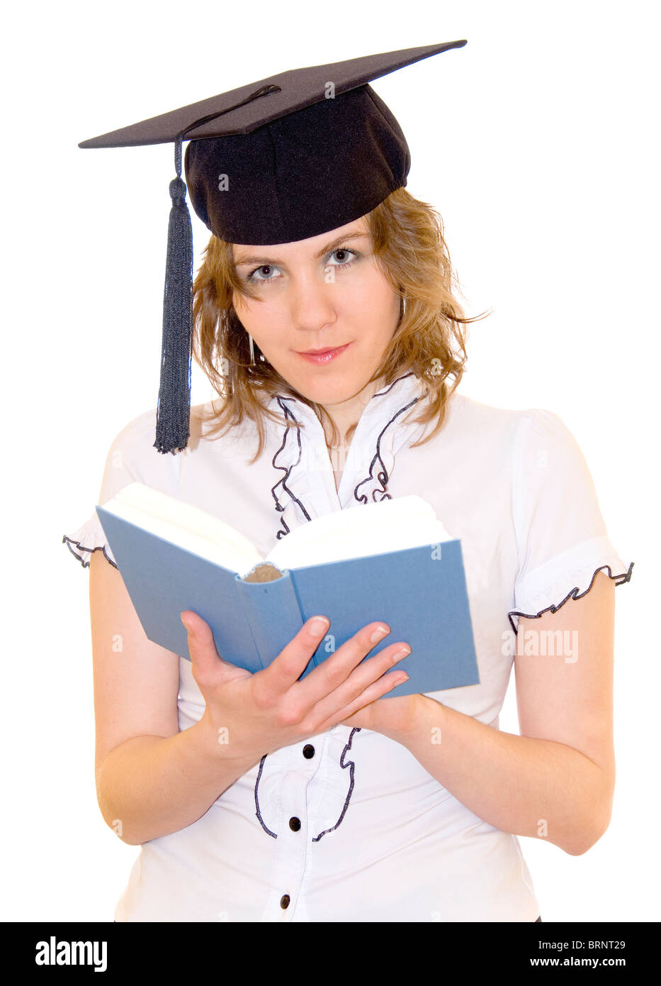 Young women in student hat reading a book, isolated on white background Stock Photo