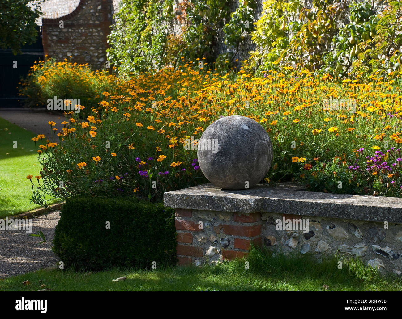 flower border with low wall west dean gardens Stock Photo