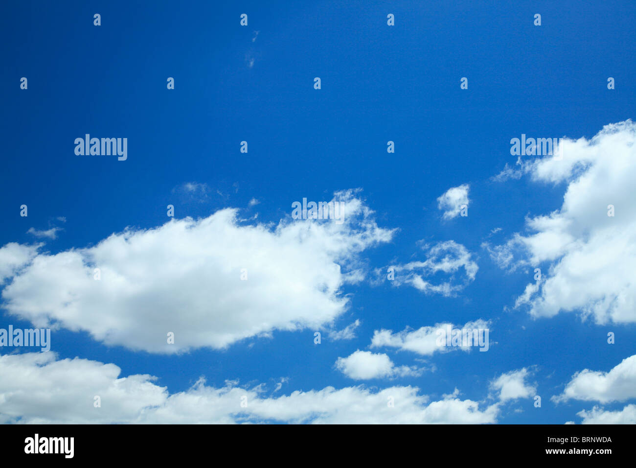 White Cumulus Clouds and Blue Sky Stock Photo