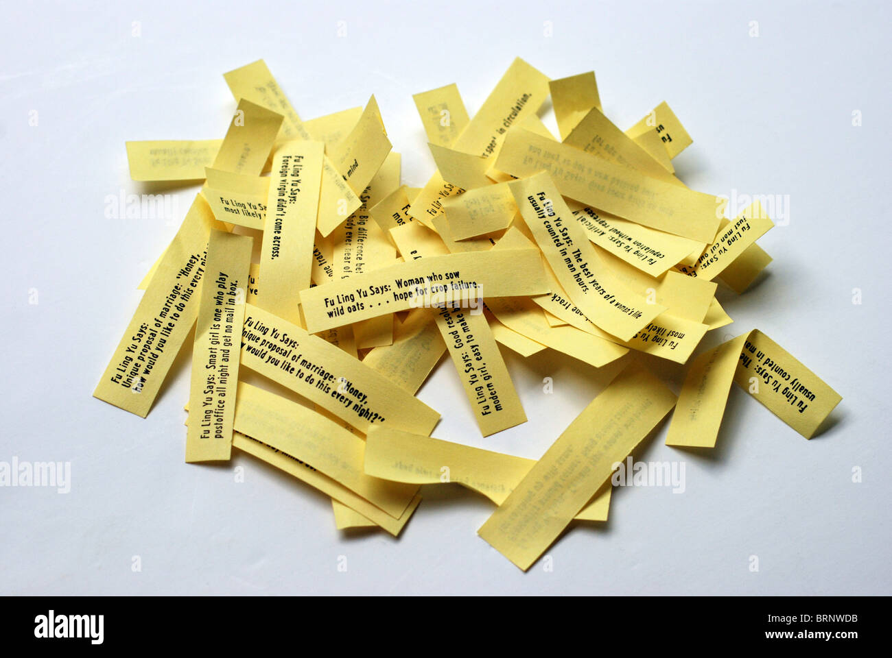 Pile of cheeky Fortune Cookie sayings on a white background Stock Photo