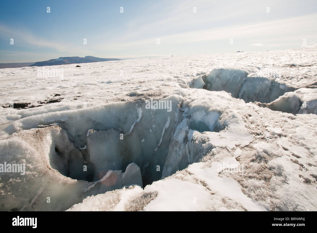 A moulin or meltwater sink hole on the Langjokull glacier which is retreating rapidly due to climate change. Stock Photo