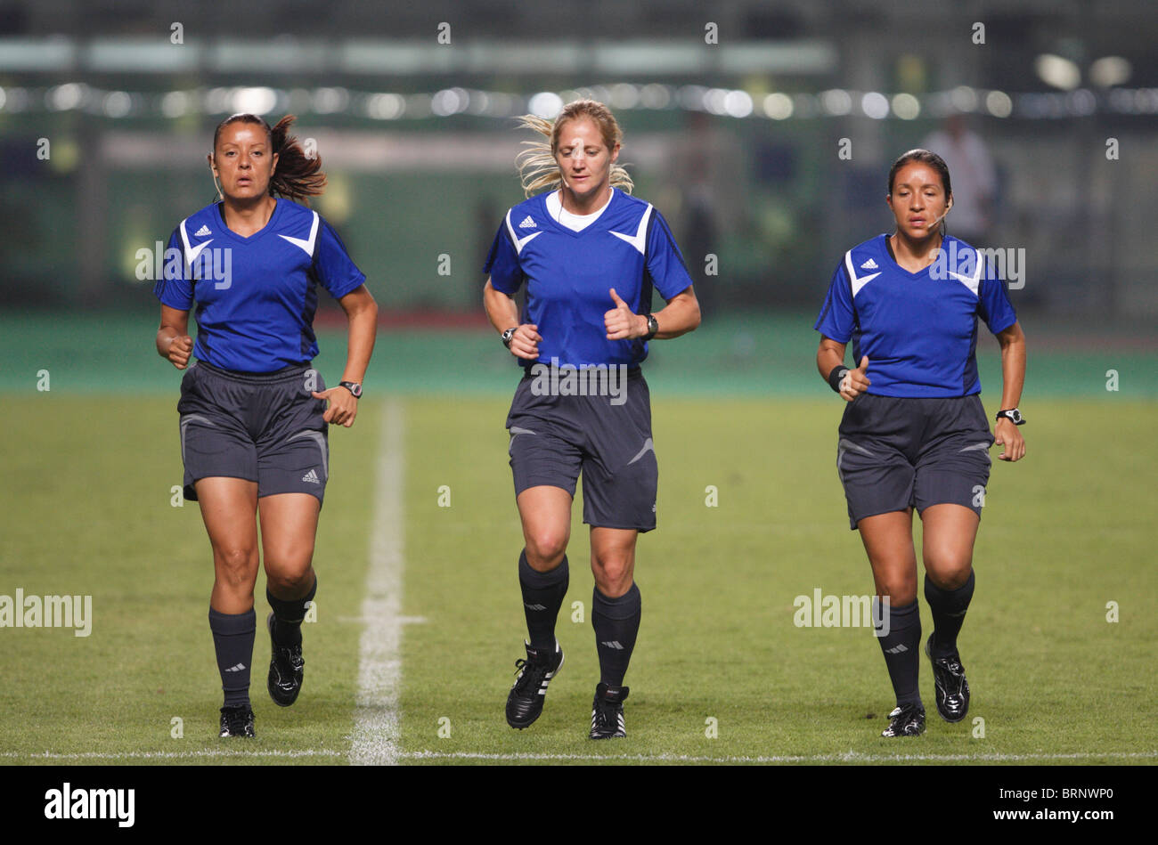 Referee Jennifer Bennett (c) warms up with her assistants prior to a 2007 Women's World Cup match between China and Brazil. Stock Photo