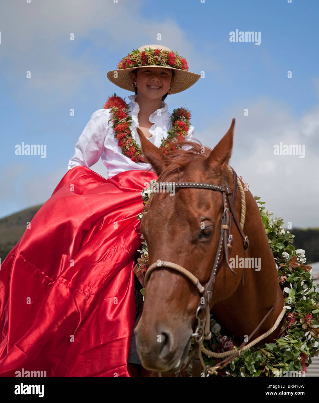 Young girl and horse adorned with floral decorations for the 35th annual Waimea Paniolo Parade on the Big Island Stock Photo