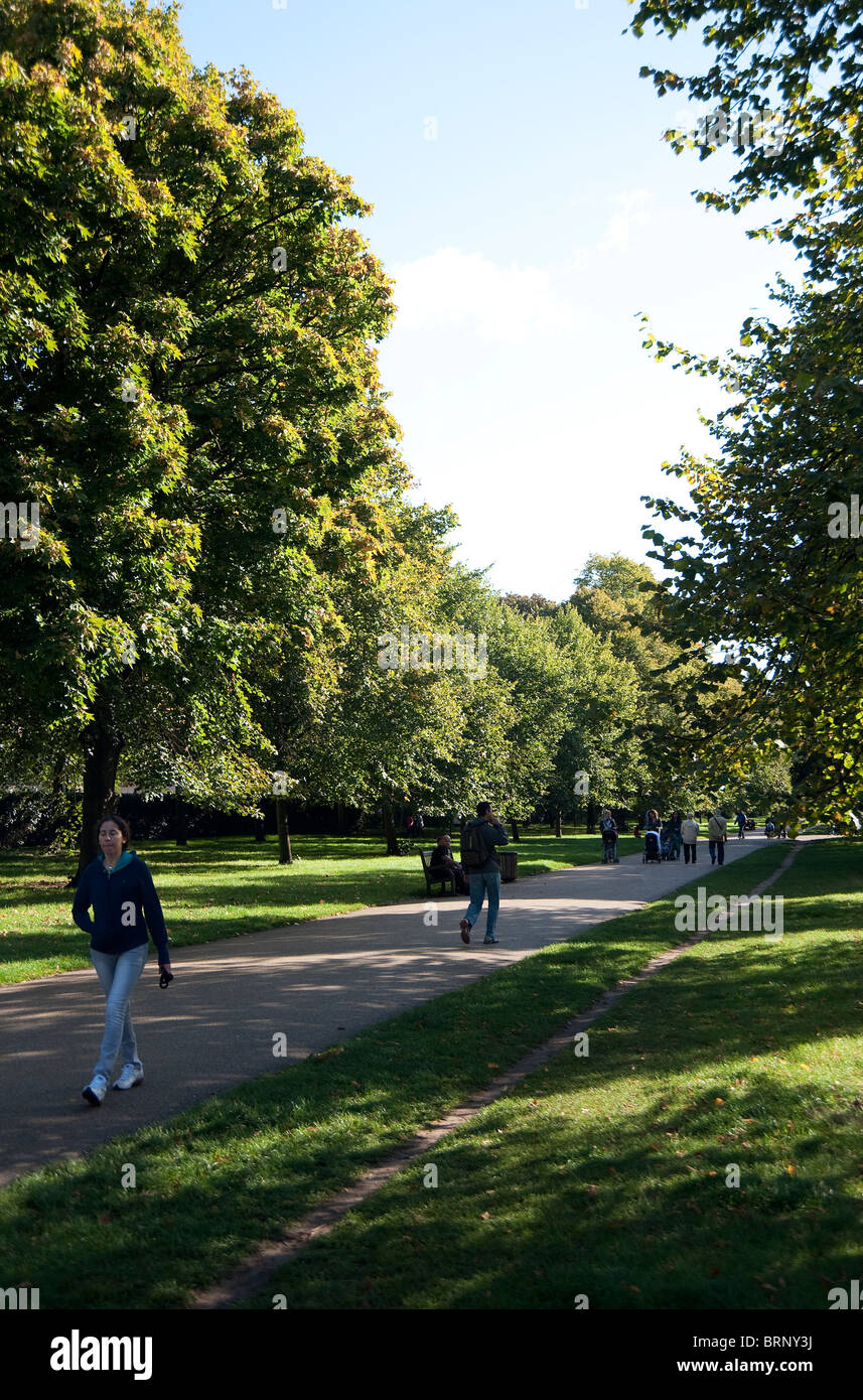 People walking in Kensington Gardens, London, UK Stock Photo