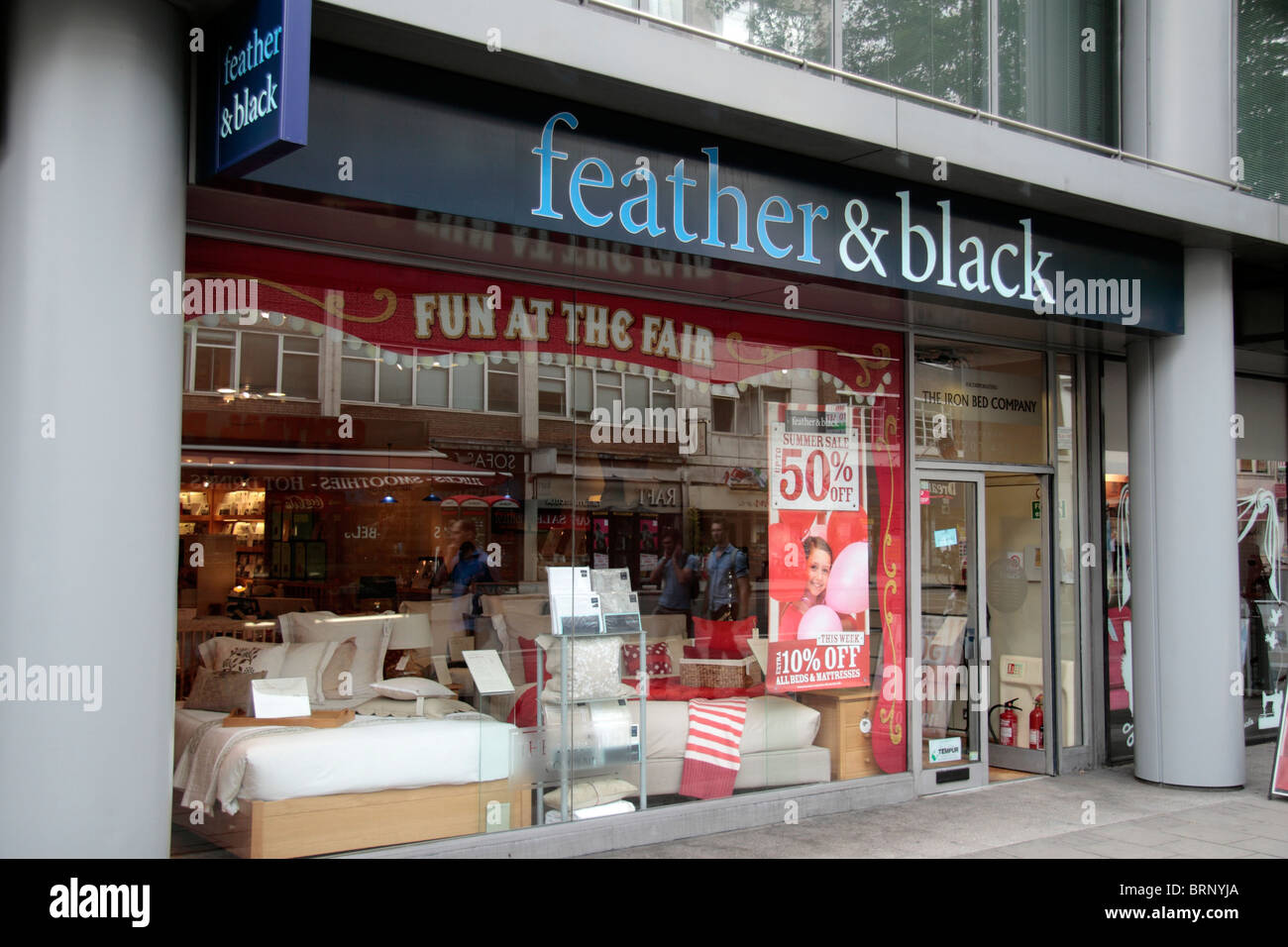 The store front of the Feather & Black bedroom furniture & bedding store, on Tottenham Court Road, London, UK. Stock Photo