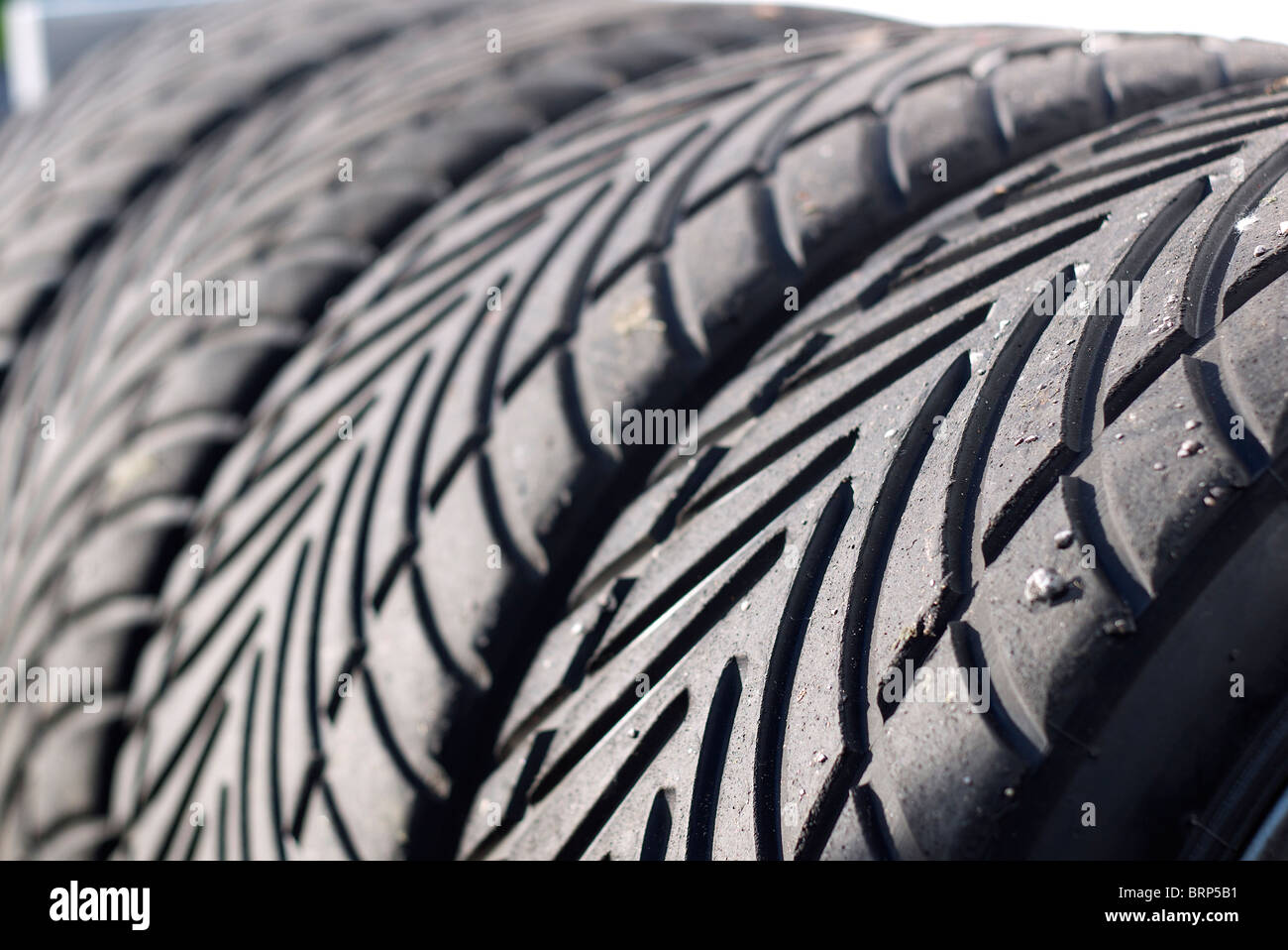 Racing Tyres in a rack Stock Photo