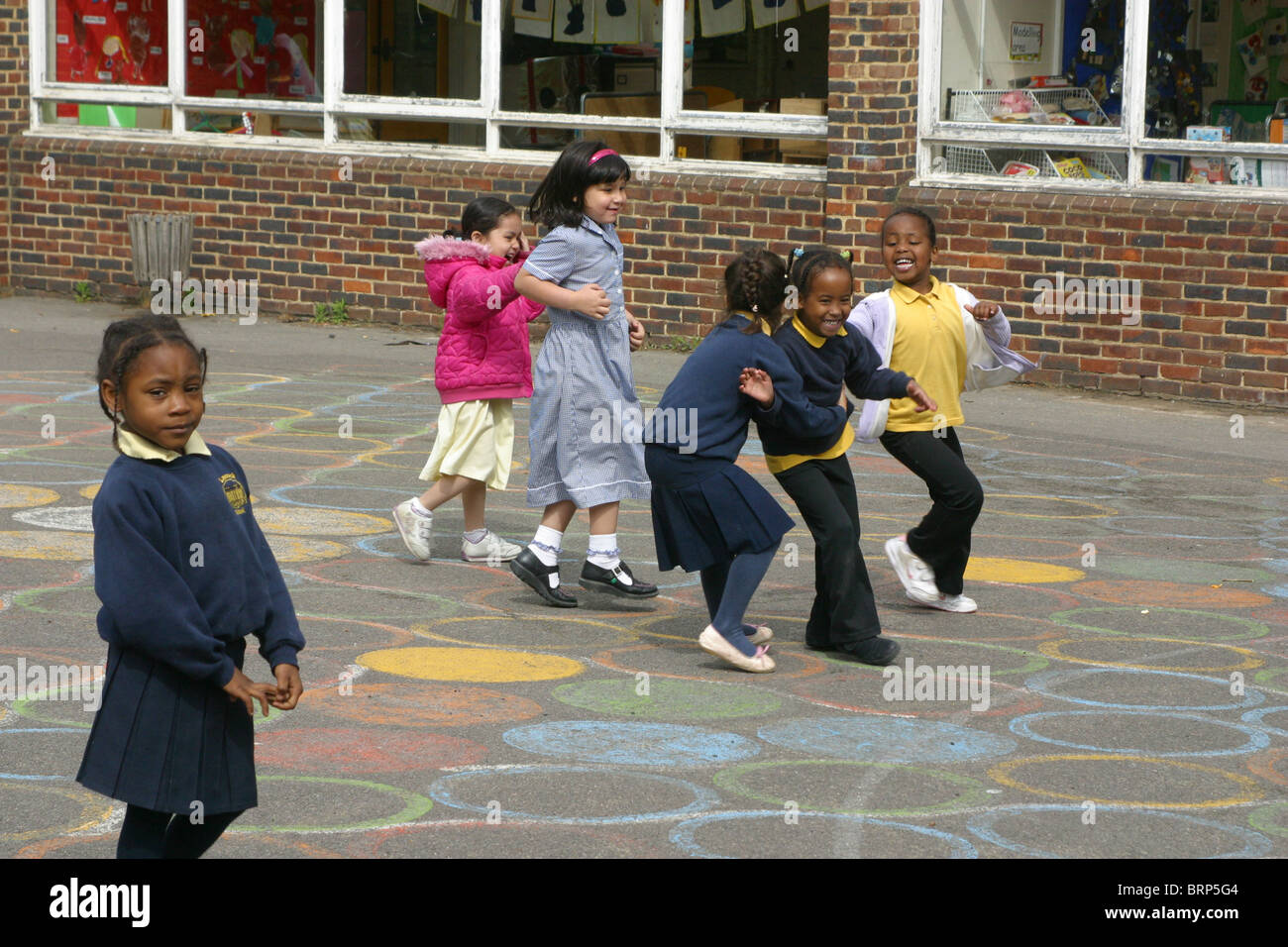 Reception children playing in the school playground Stock Photo